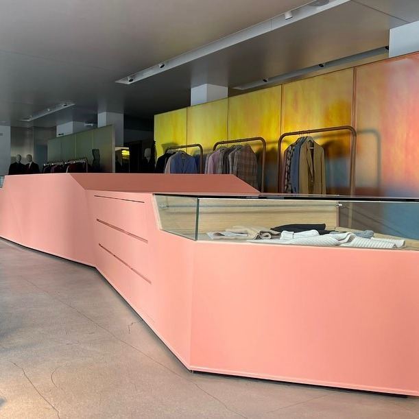 Retail counter wrapped in coral vinyl